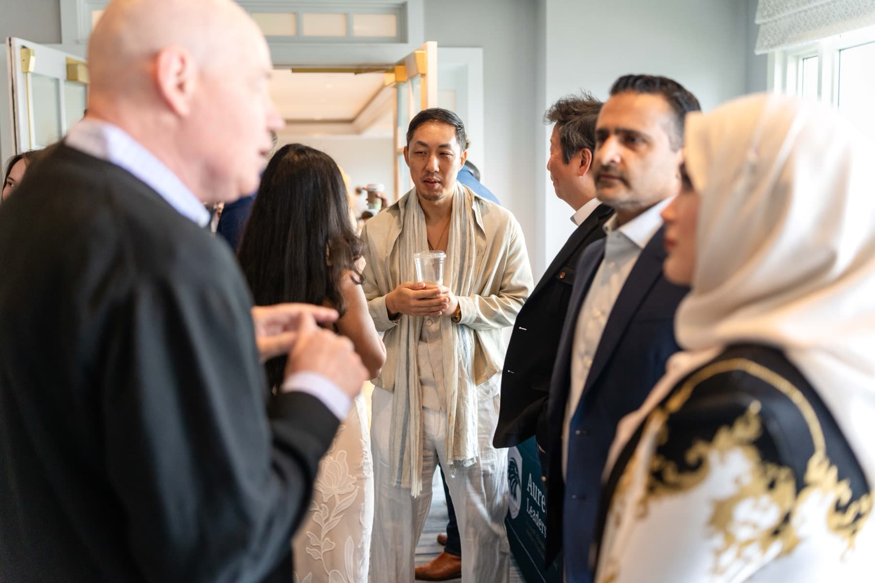 Aureum members in conversation at a private gathering