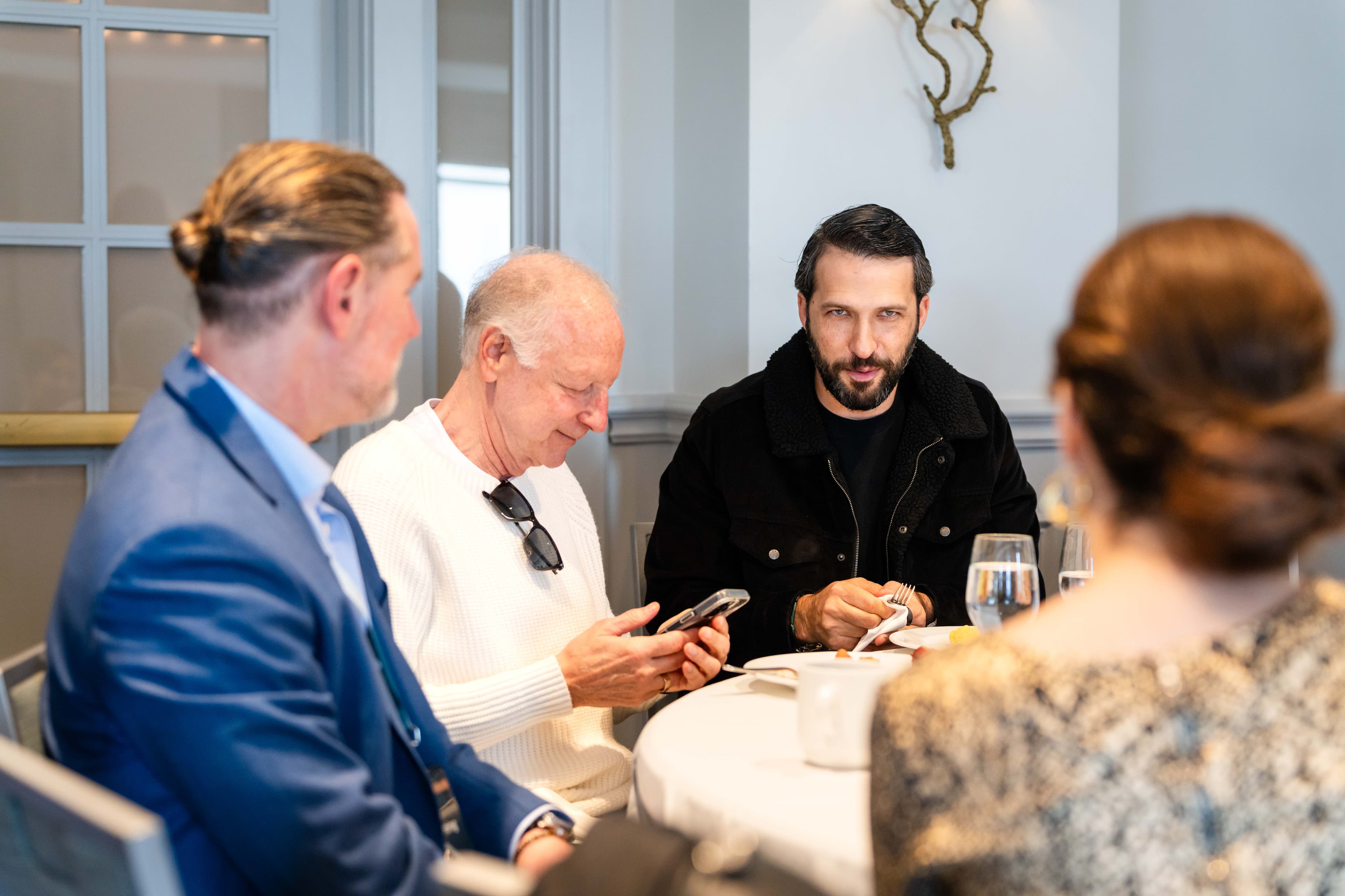 Aureum members in private conversation at a partner gathering