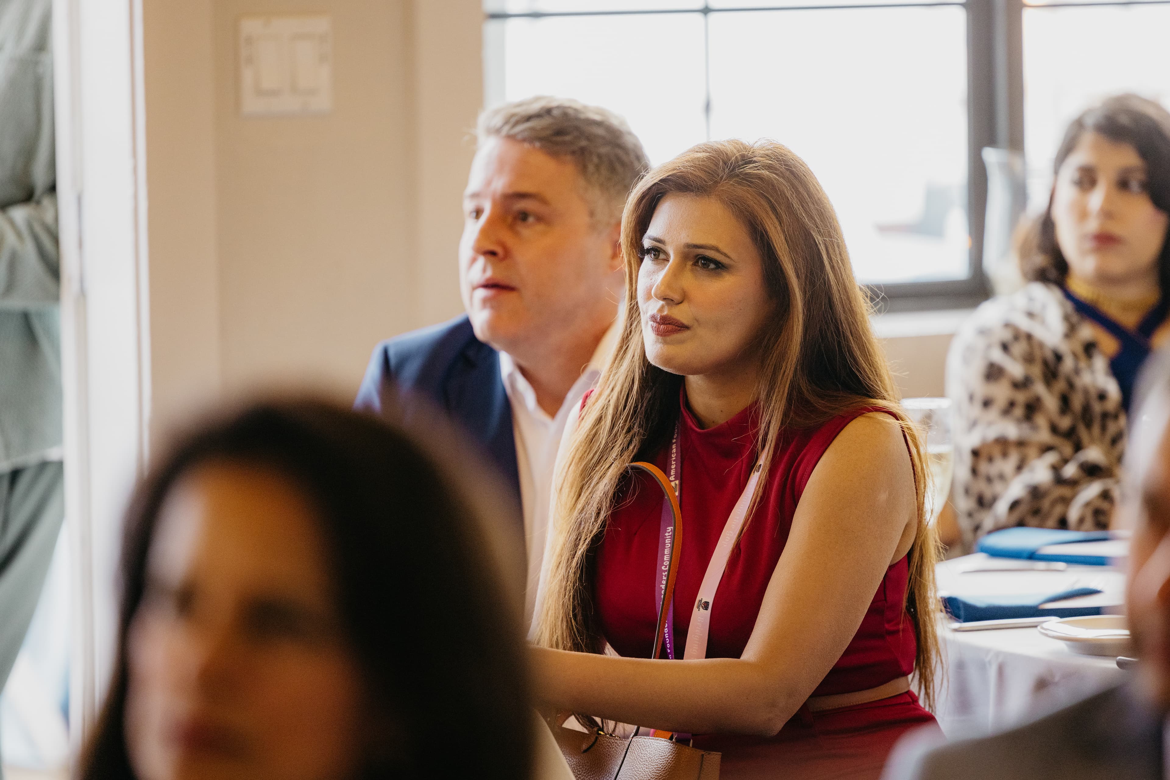 An Aureum member listening intently at a private gathering